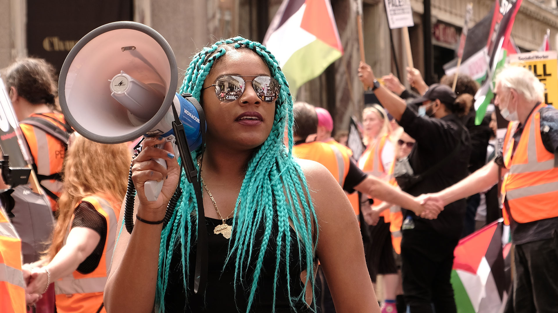 Chantelle Lunt holding a megaphone at a protest