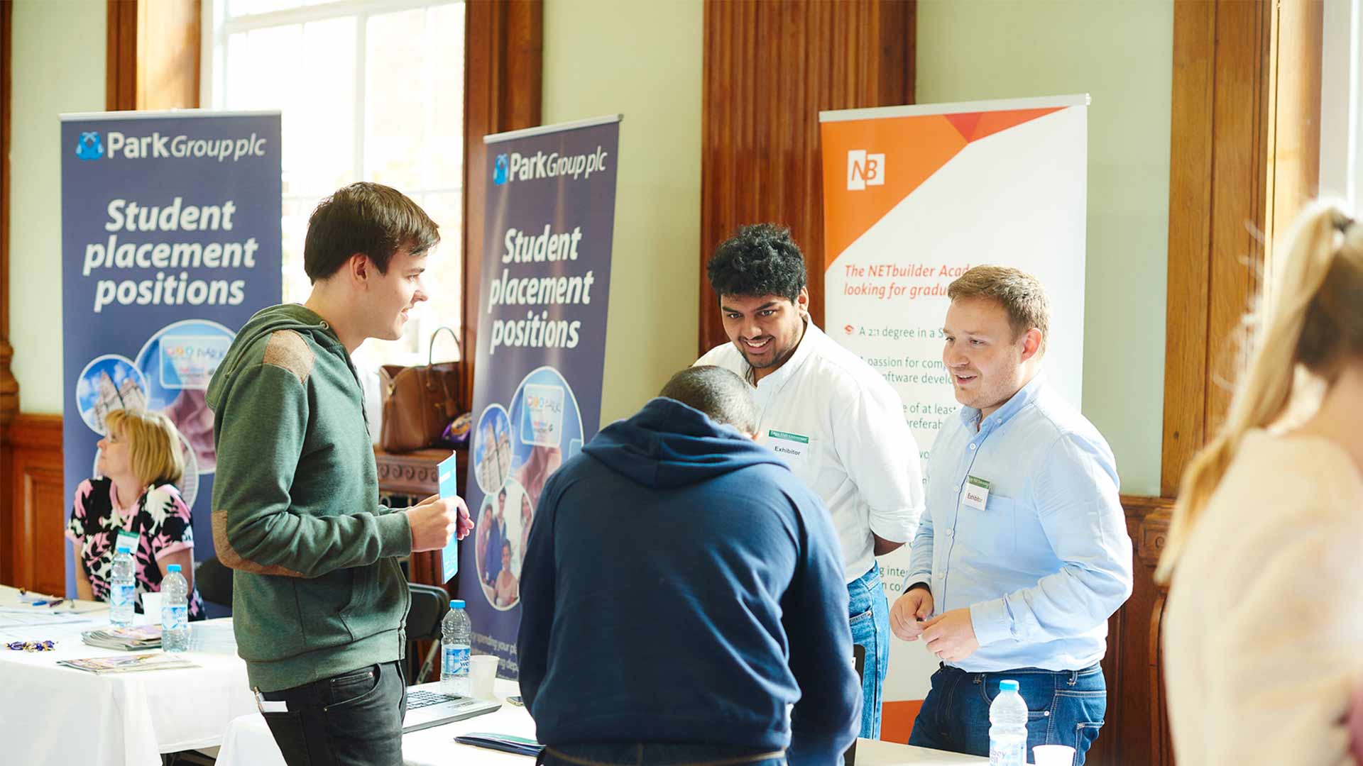 Students talking to visitors at a Careers Fair in Hale Hall.