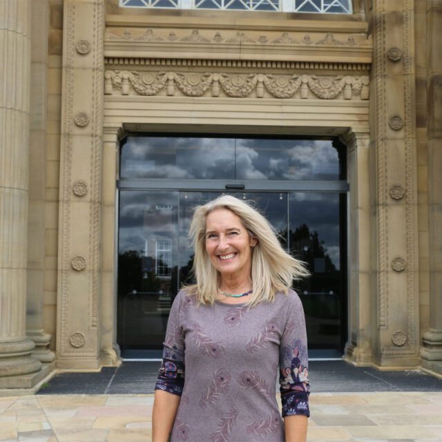 Alumni Kay Billingsley outside Edge Hill's Main Hall.