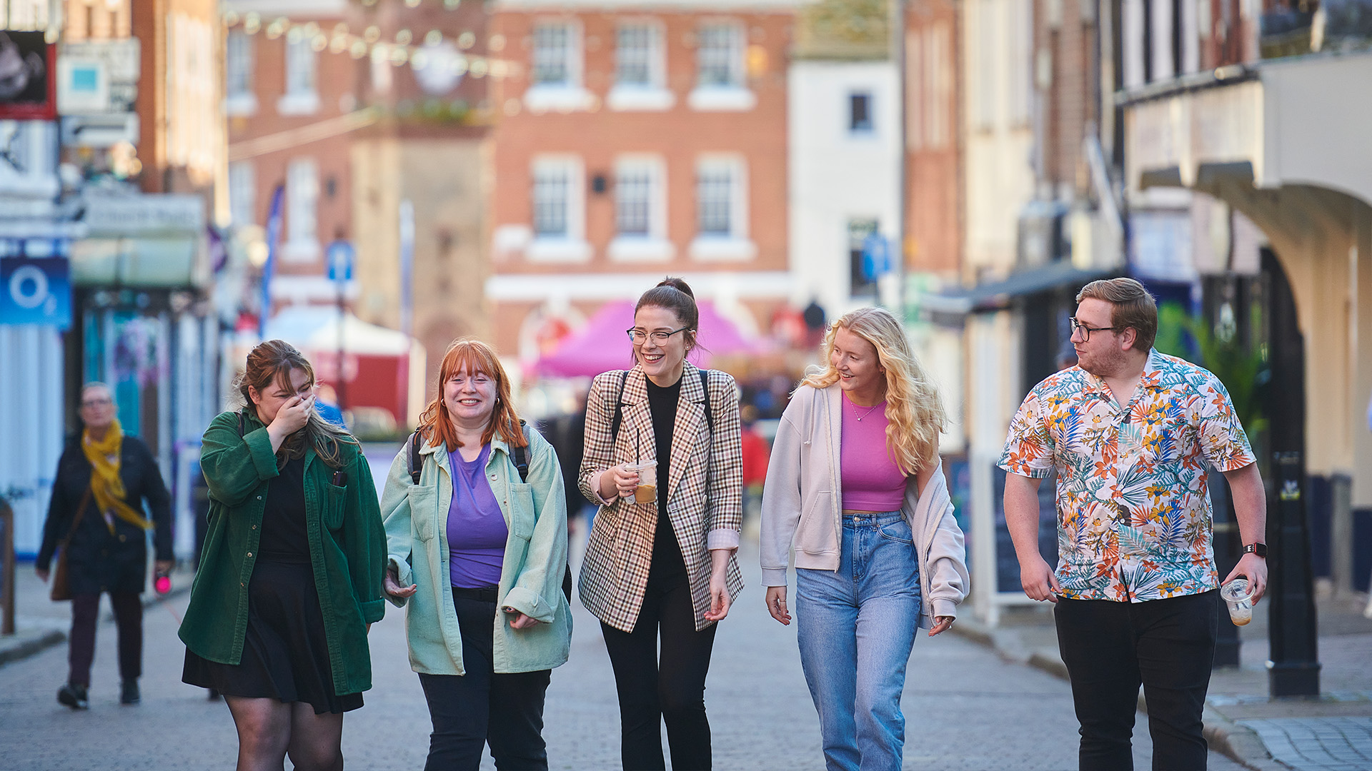 group of students including male and female walking through Ormskirk town centre together