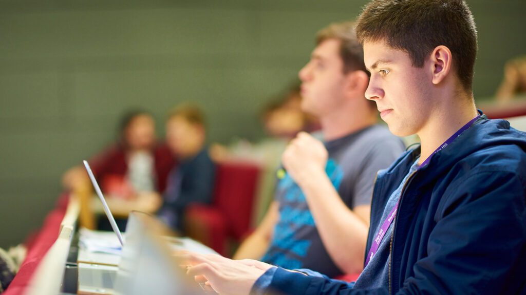 Physics students taking lecture notes