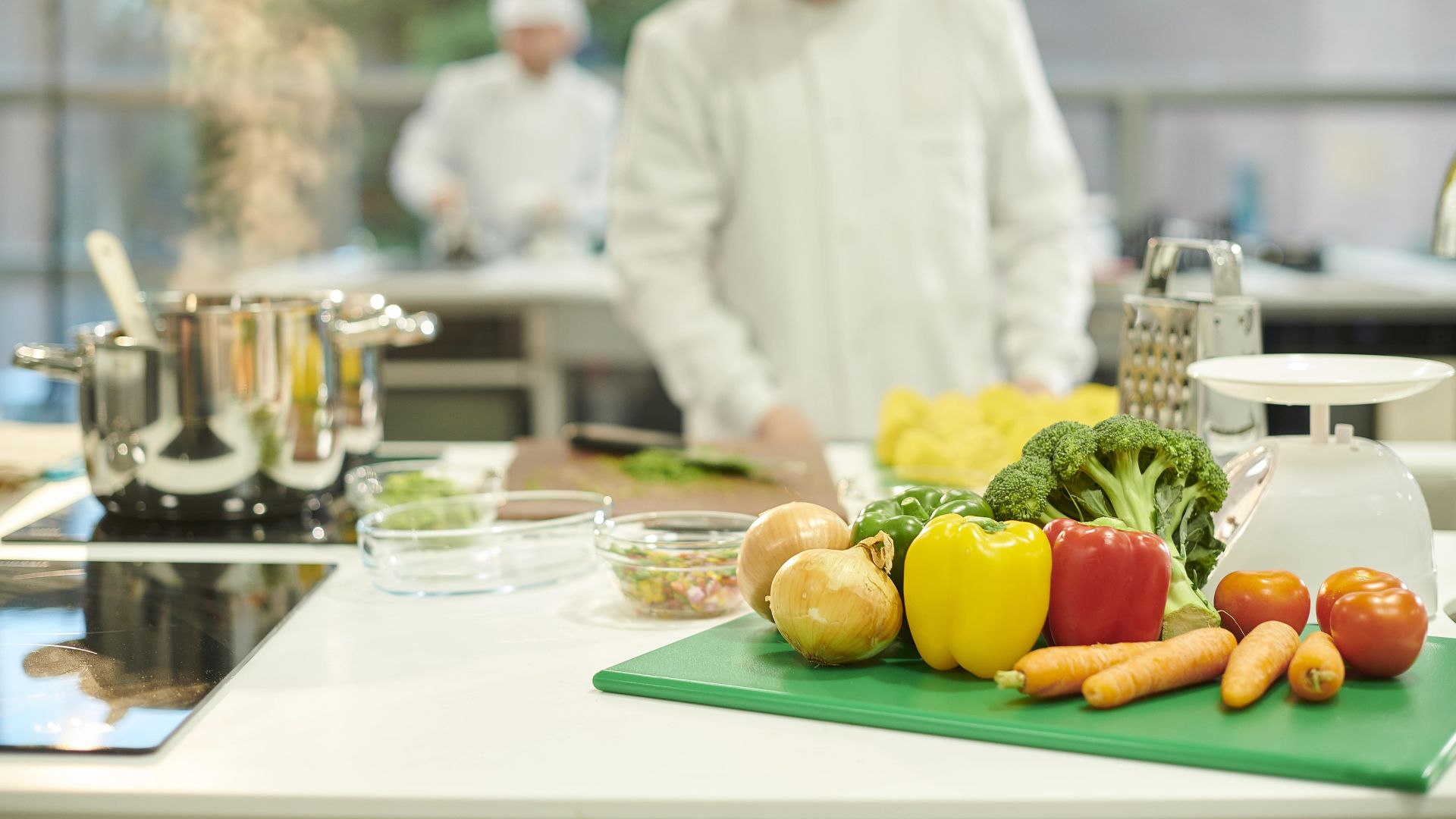 Close up of food lap table with fresh fruit and a pan on the hob