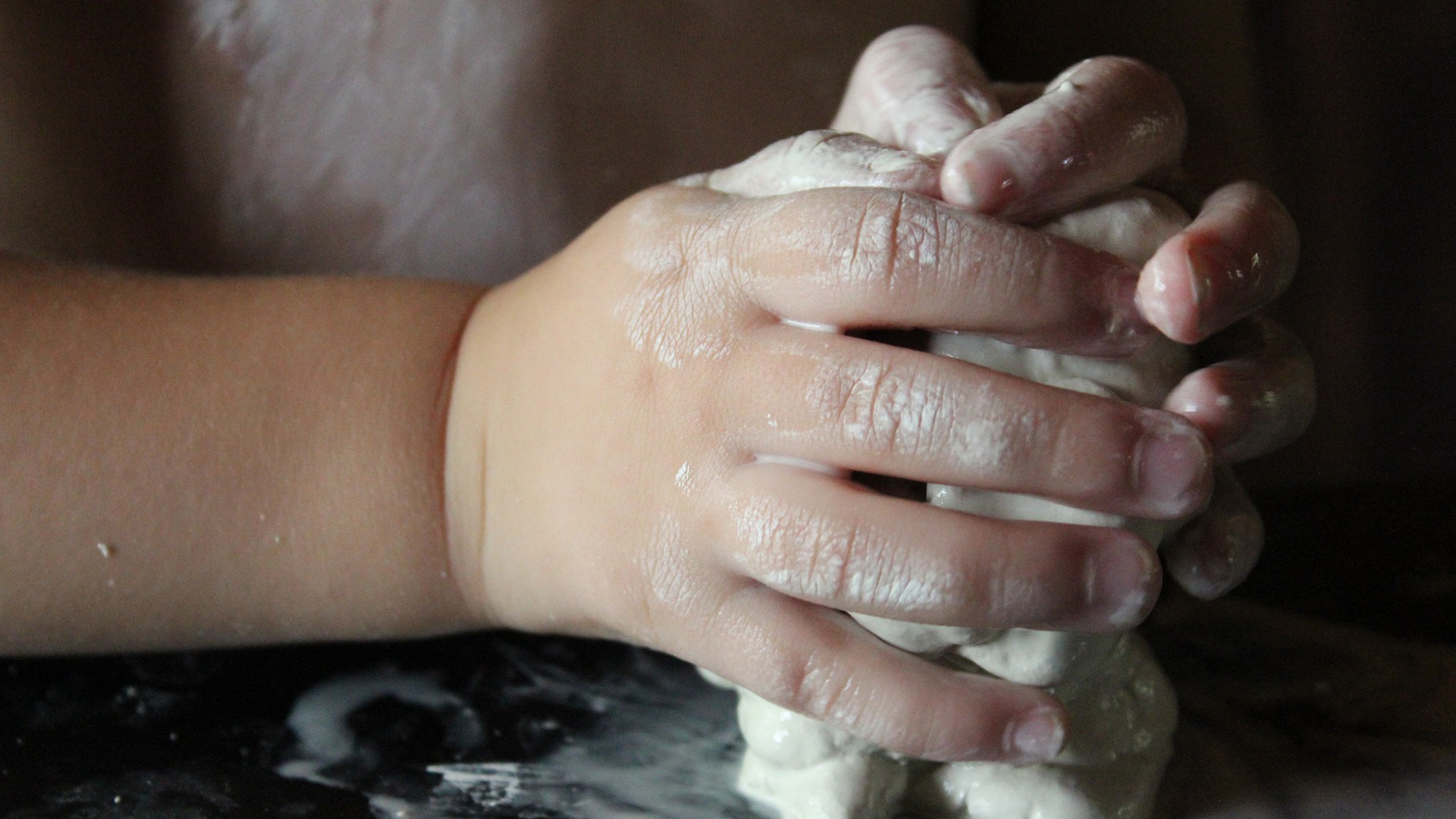 A child moulding clay