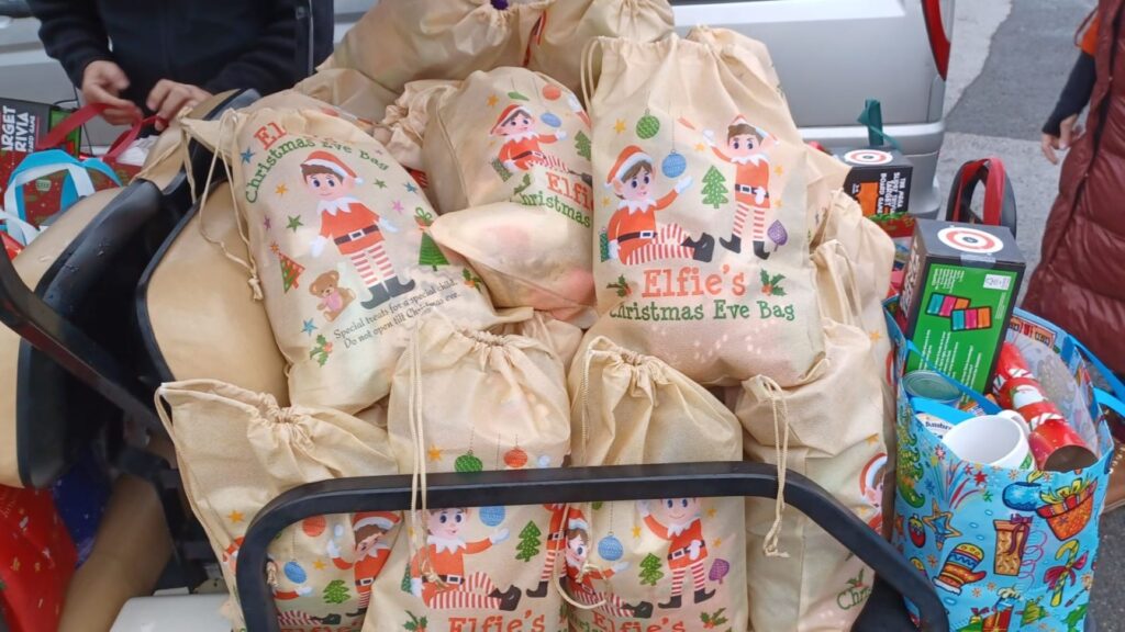 A picture of bags of presents with "Elfie's Chrsitmas Eve Bag" written on them.