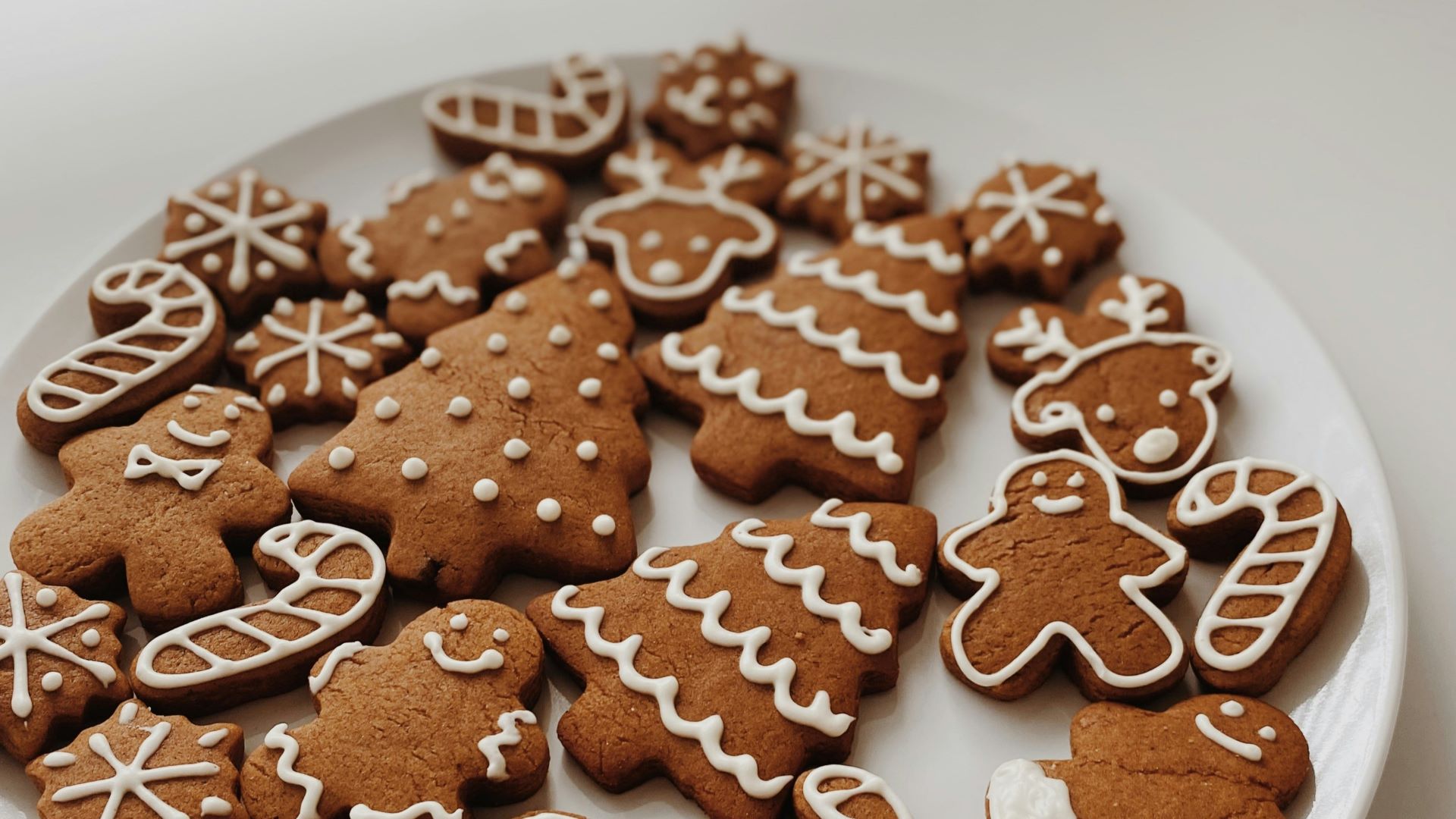 A picture of gingerbread in the shape of men, trees and candy canes.