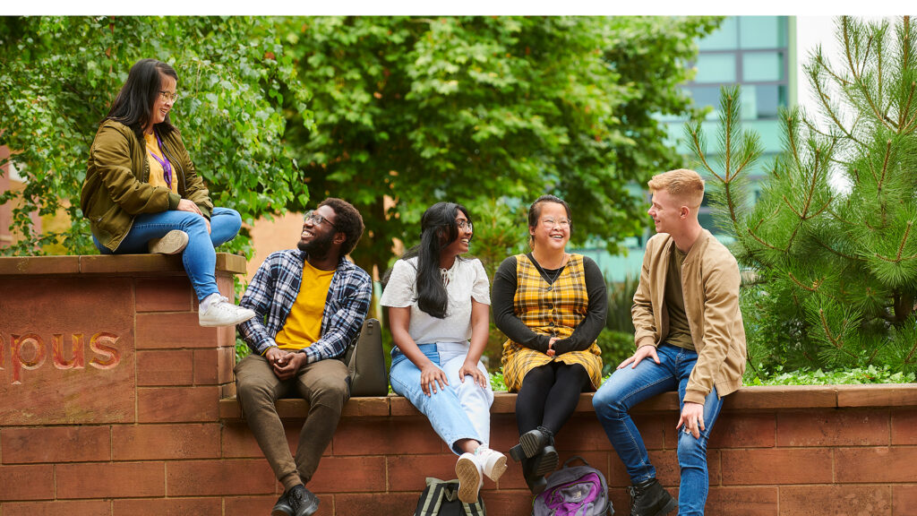 A group of students engaging in conversation on campus.