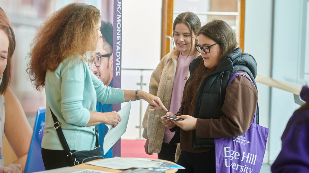 Students seeking money advice at a fair on campus.