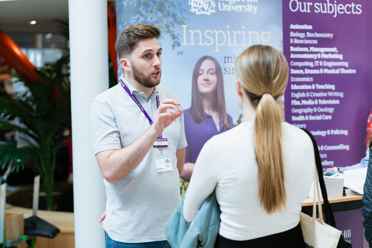 An Edge Hill staff member gives advice to a prospective student.
