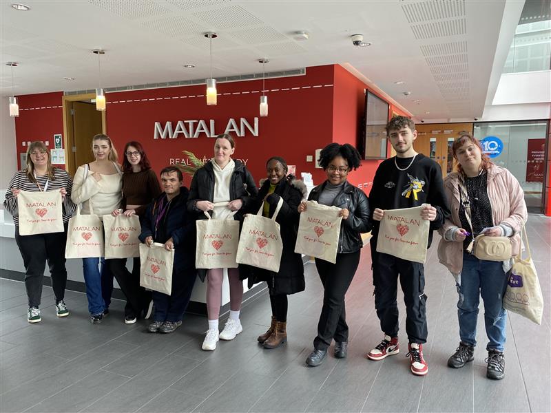 Students stood in a line holding matalan bags during a recent visit to the businesses headquarters.