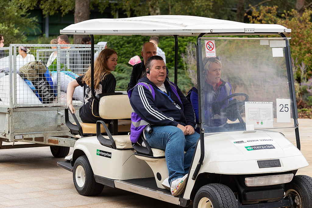Jon on a buggy supporting the transport of a student's belongings as they move into campus