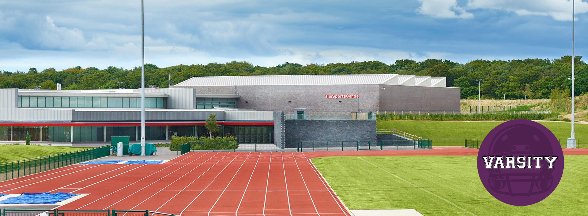 exterior shot of the sports centre with purple circle on the bottom right hand corner saying Varsity
