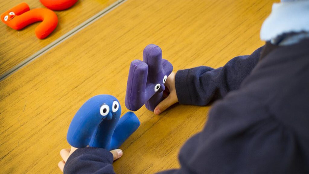 Child using number toys to assist with maths.