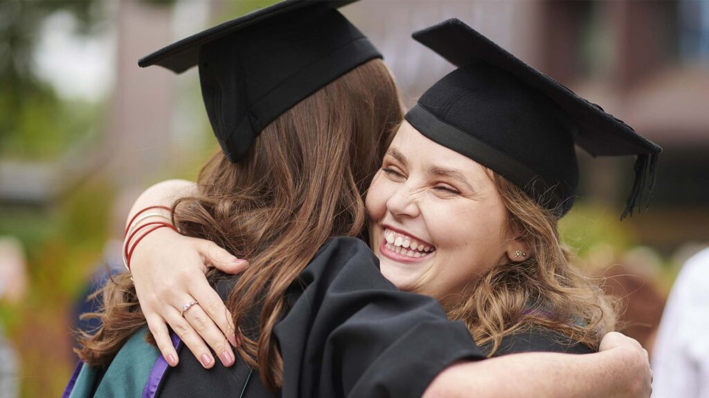 Graduates hugging each other