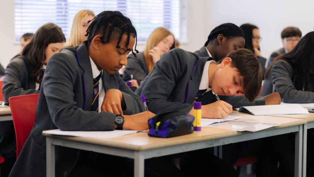 Secondary school students studying at desk