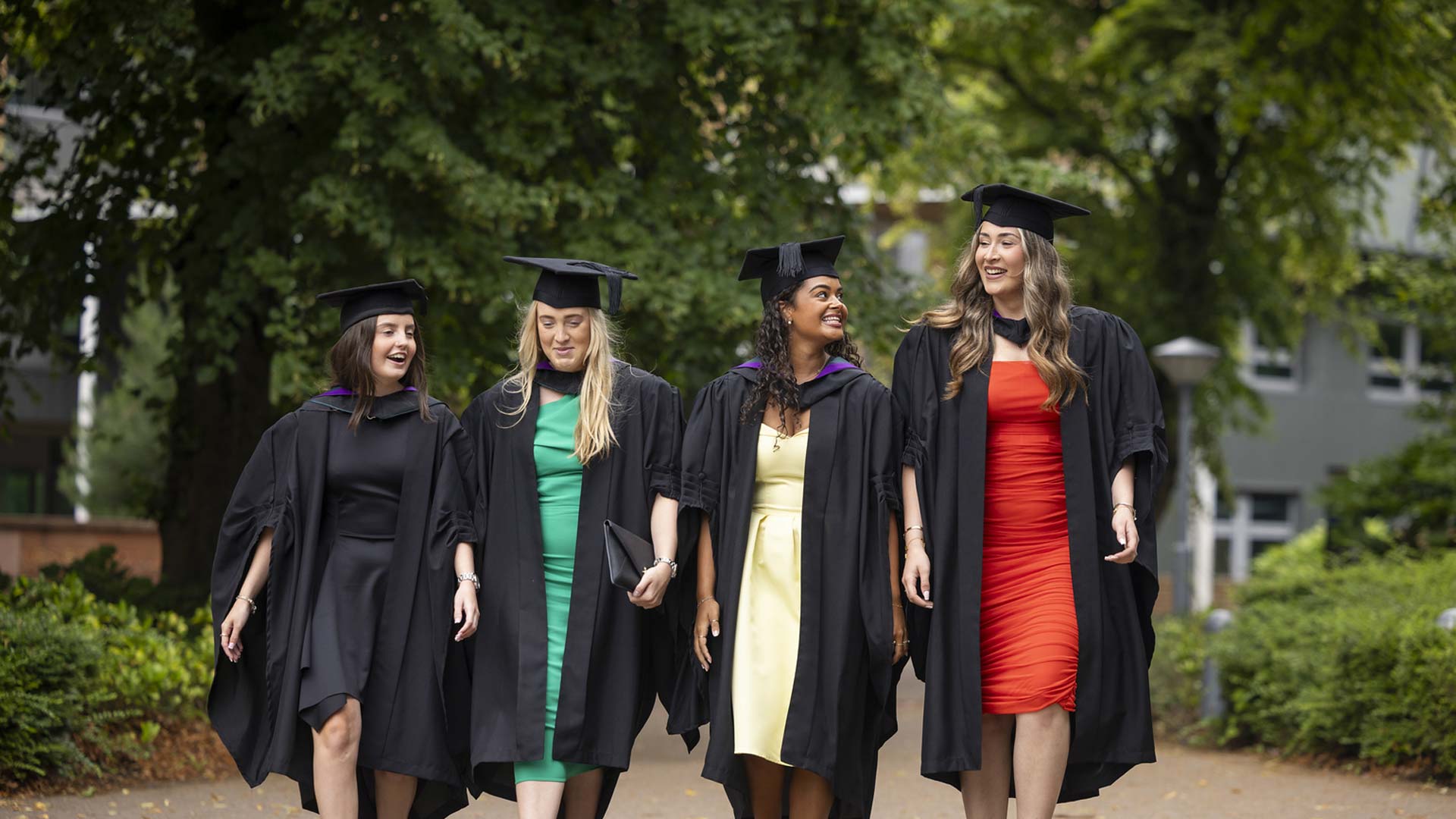 Students walk across campus on graduation day