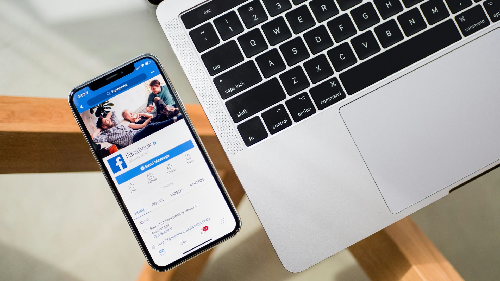 An image of a laptop next to a phone with Facebook open on the screen
