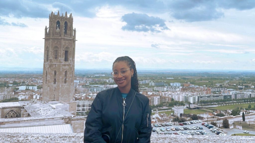 Tatiana with a Spanish tower in the background.