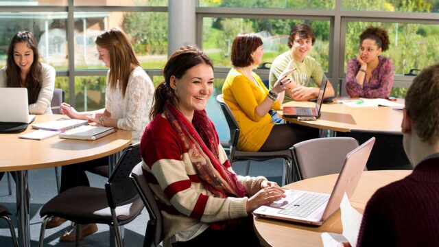 A group of professionals studying and chatting together
