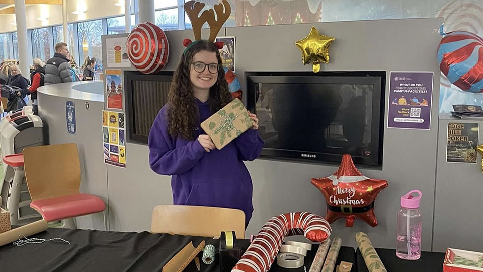 female student at craftmas lounge wrapping station