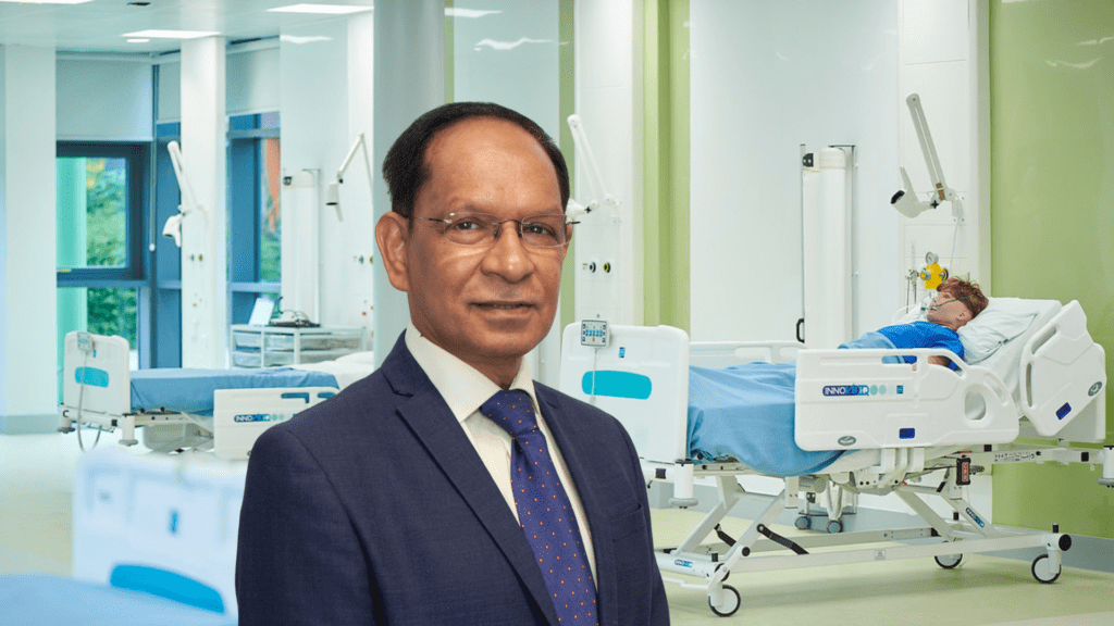Photography of Professor Sanjay Arya with health skills centre in background