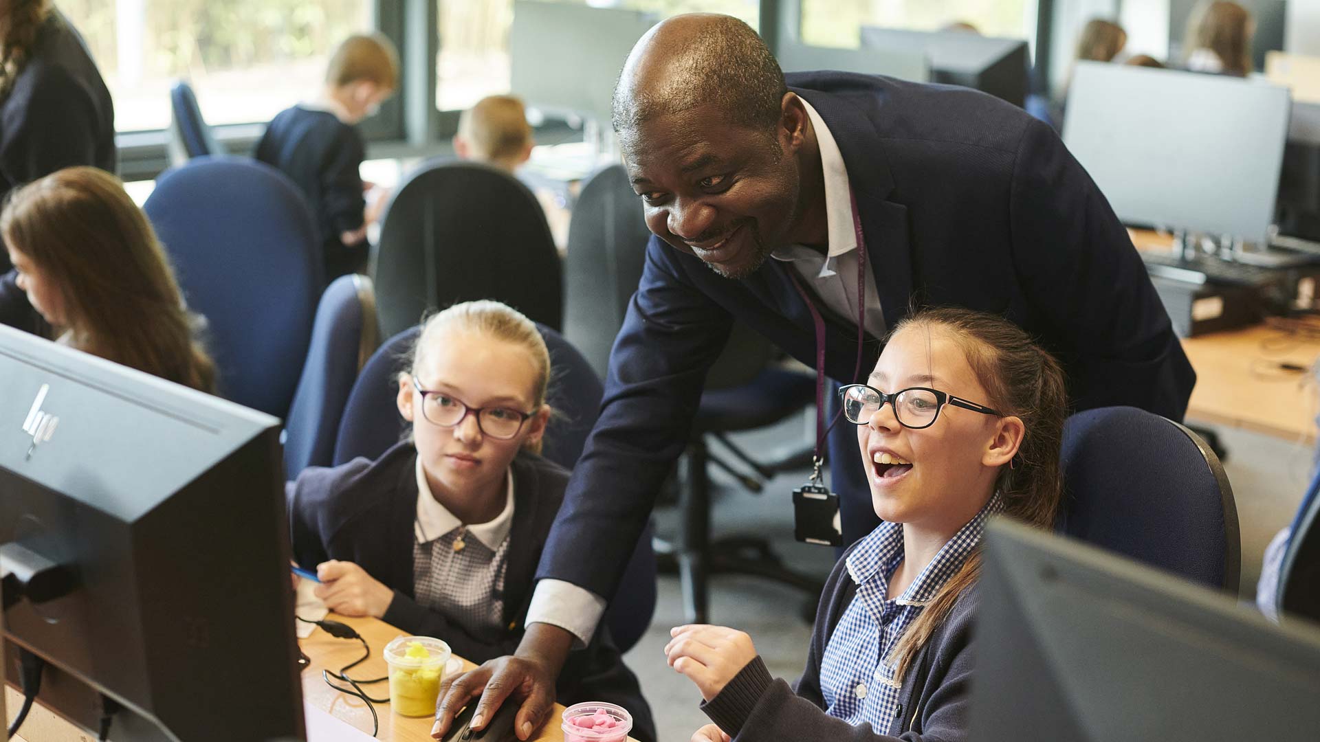 Children in a computer room with an adult