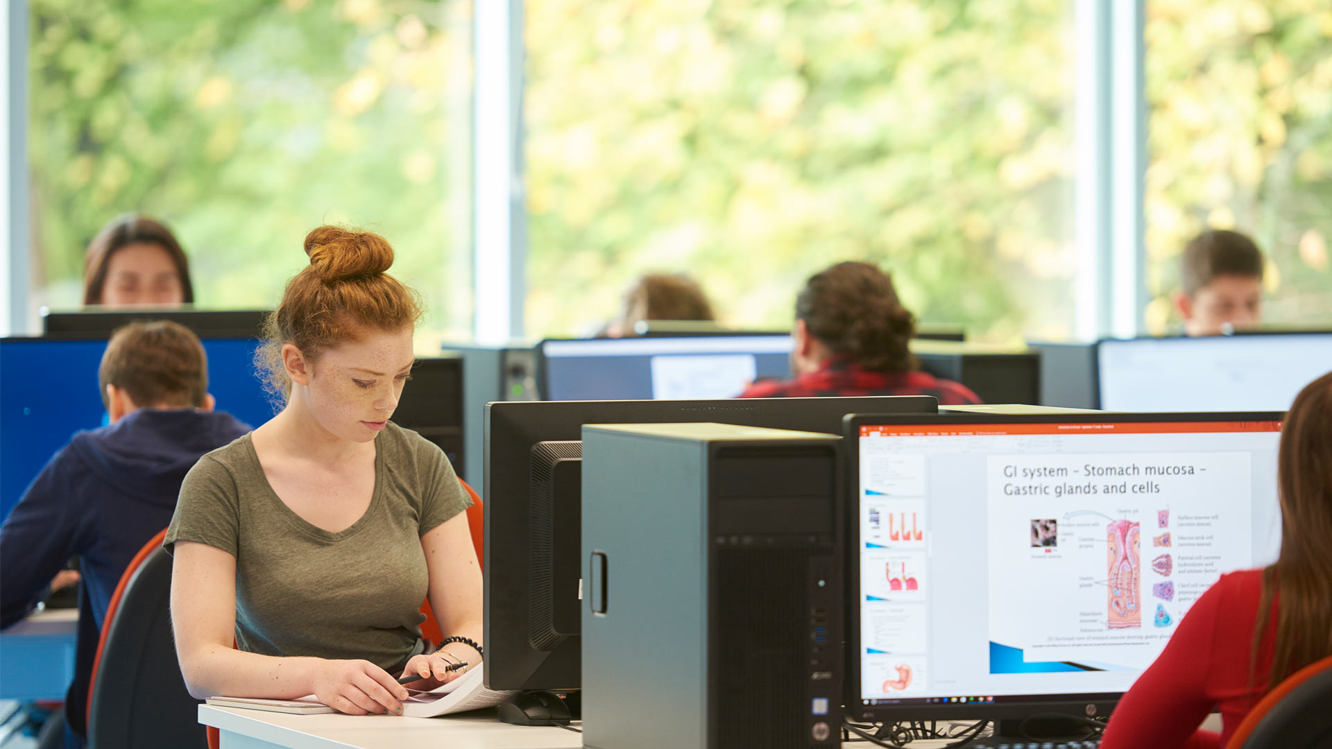 Students working on computers in library study space