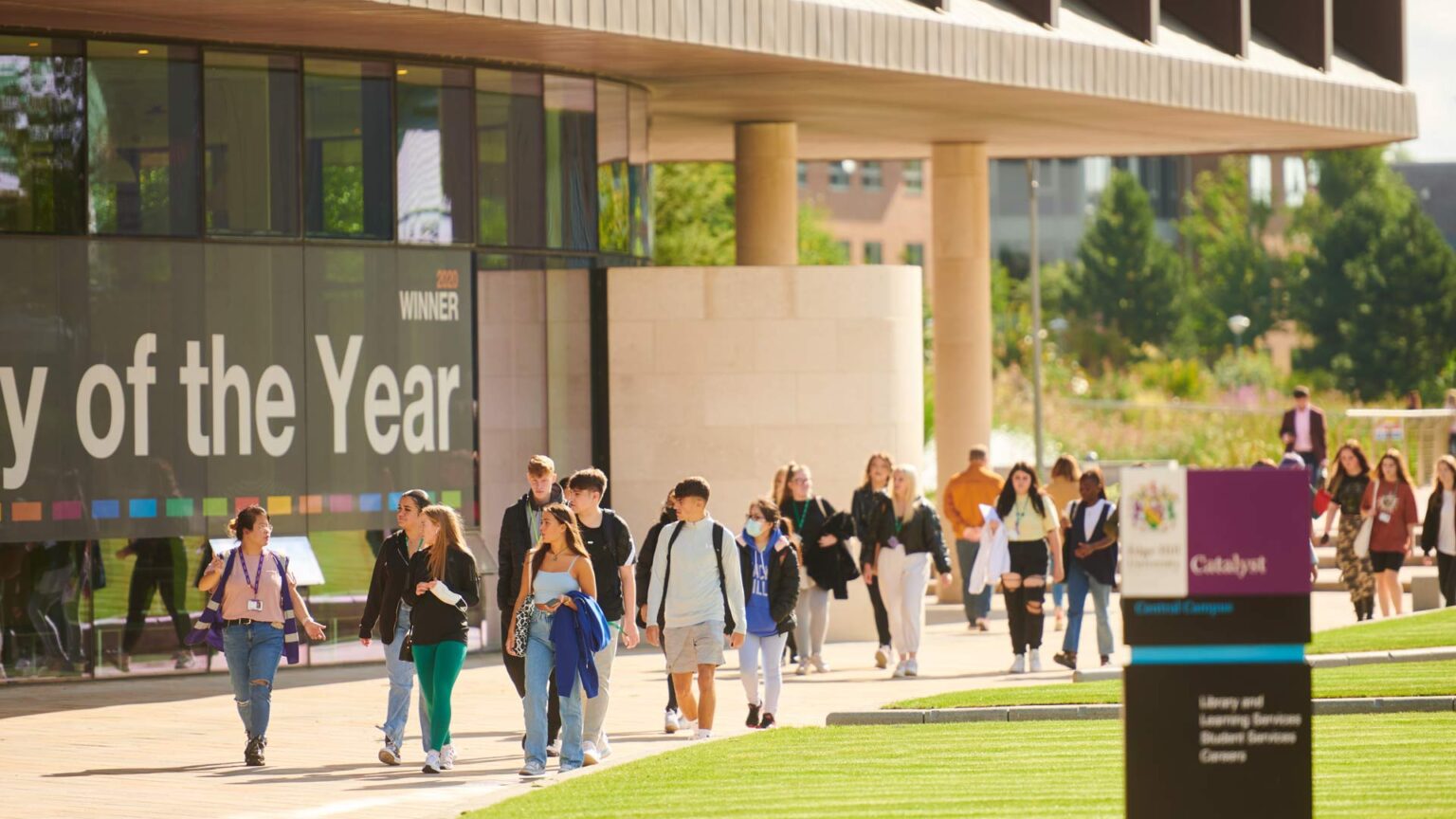 Student guide taking a group of school/college students around on a campus tour