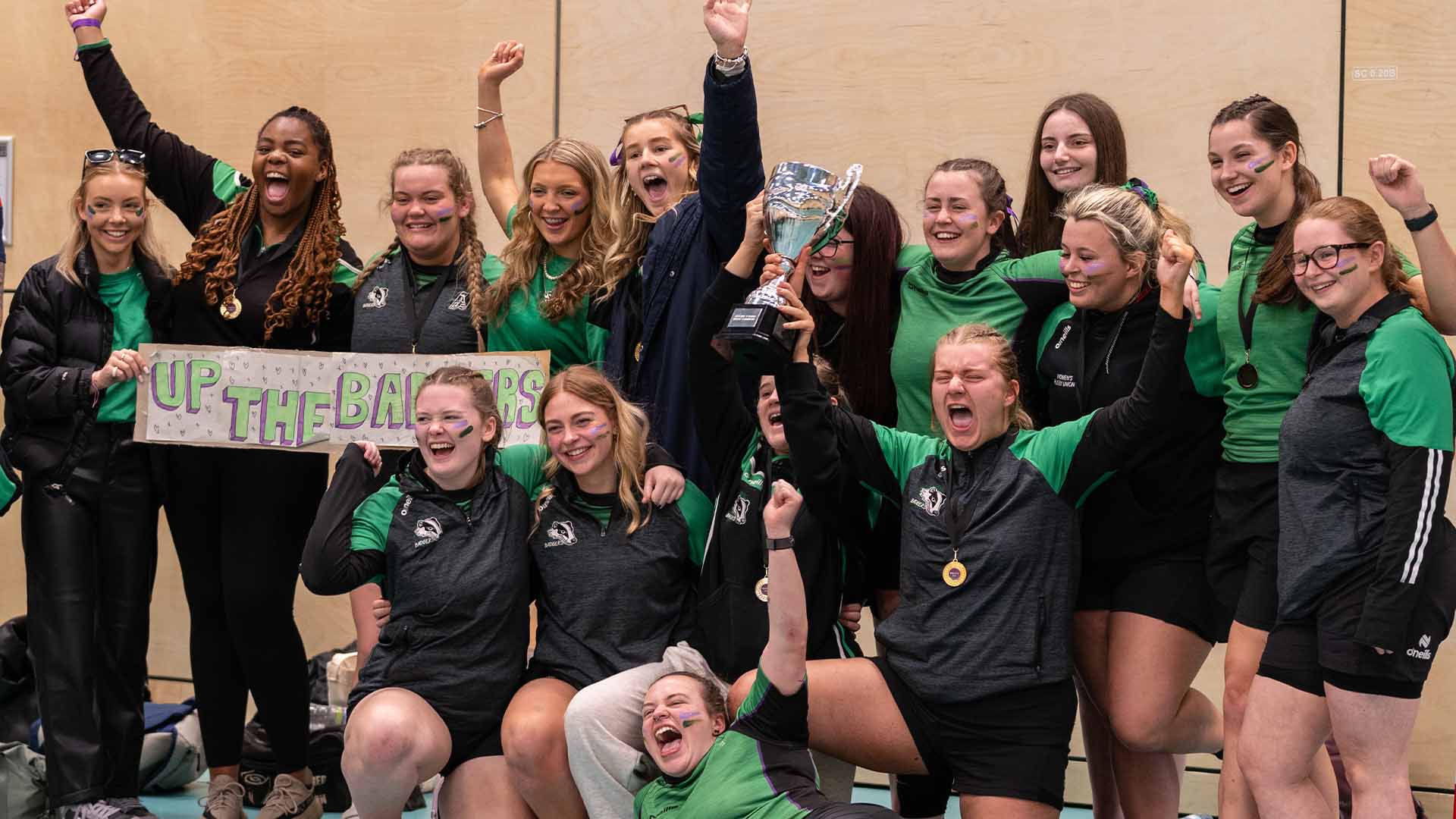group of female students celebrating their win at varsity