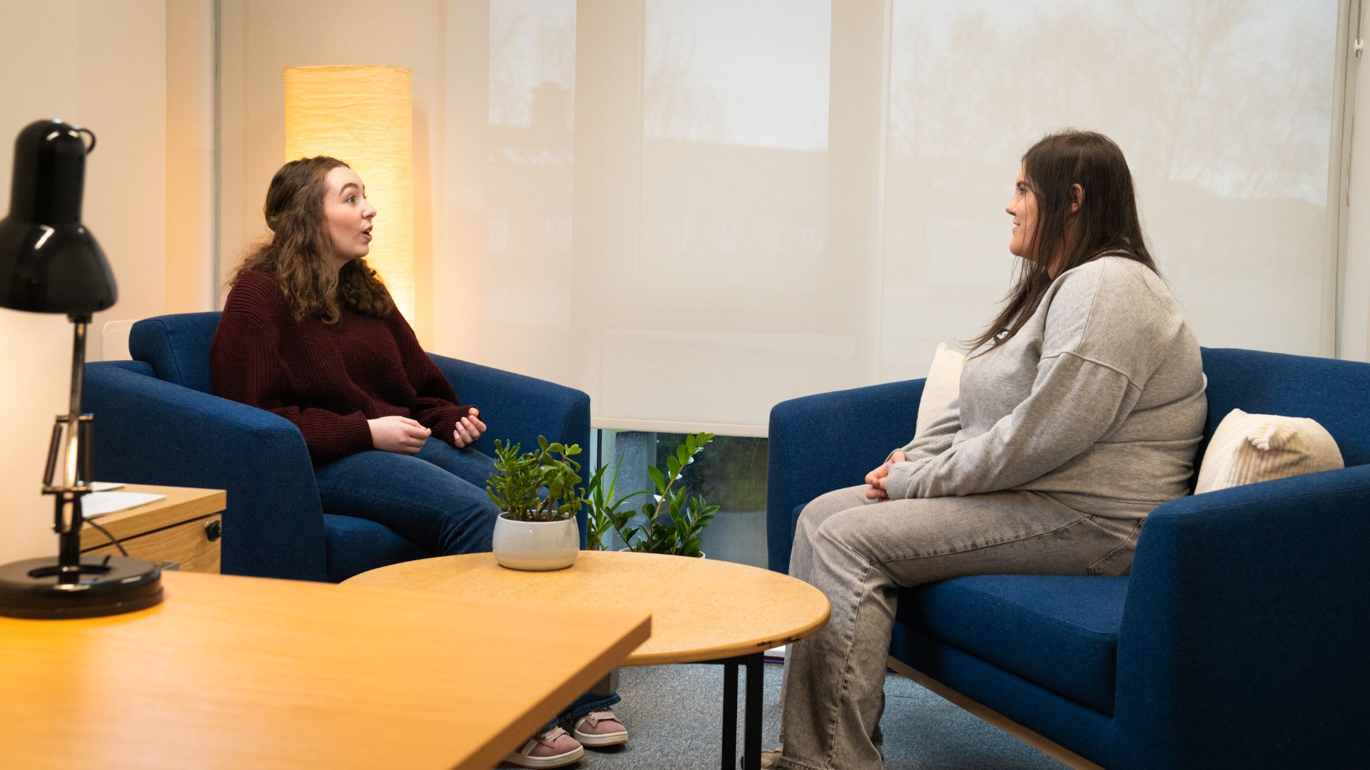 Two students sat opposite each other in the psychology coaching suite