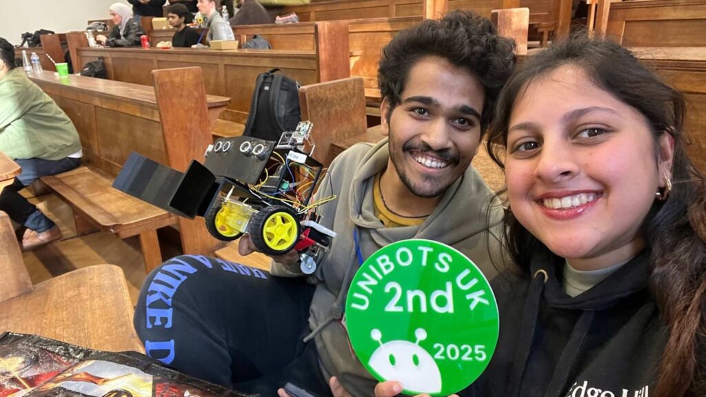 Students at Unibots competition holding a 2nd place sign and showing their competition entry