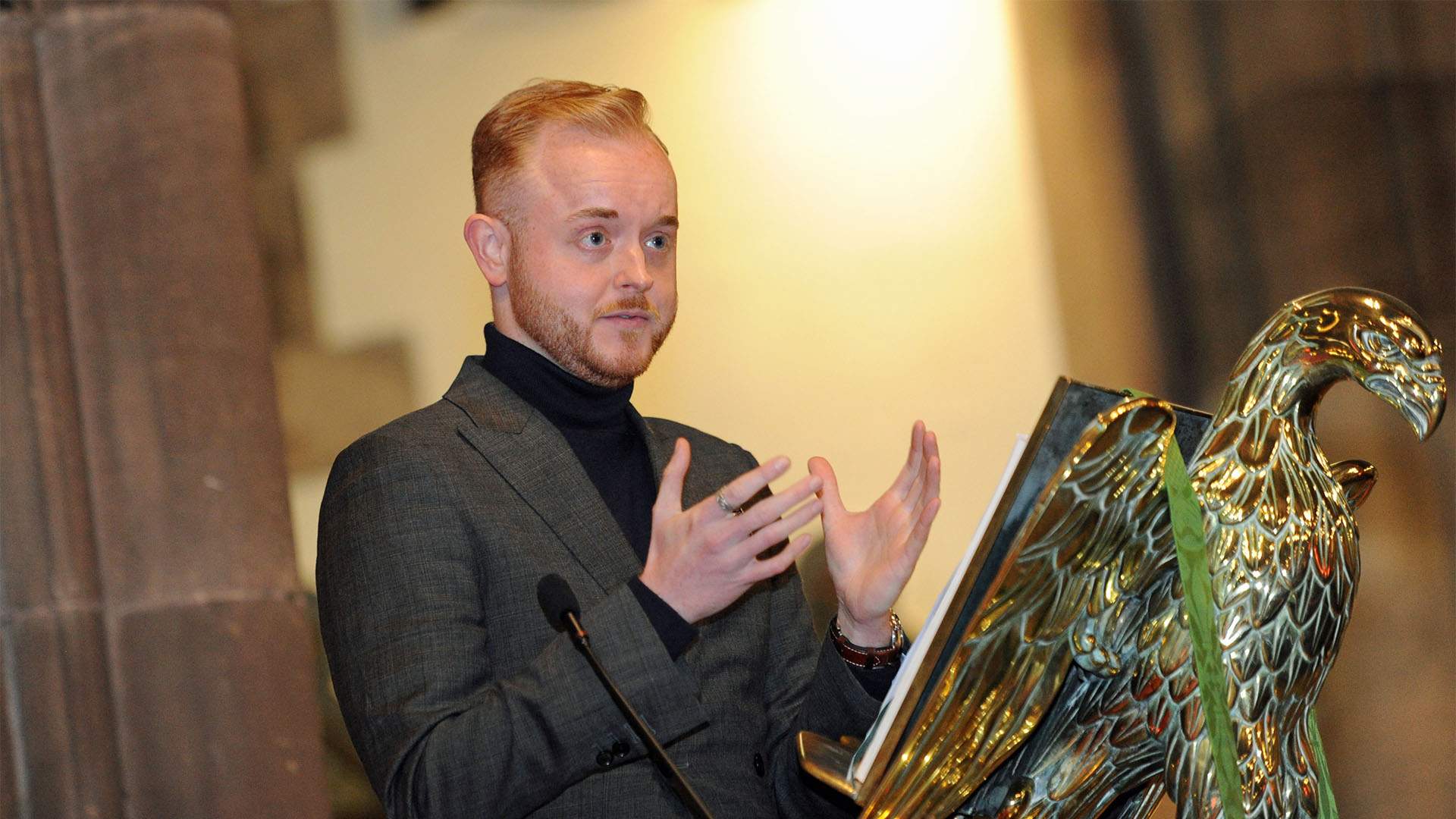Travis Frain speaking at a lectern