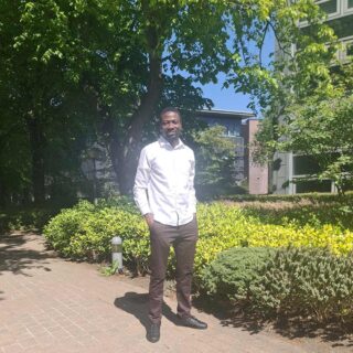 Jesse Ugwu stood on campus.