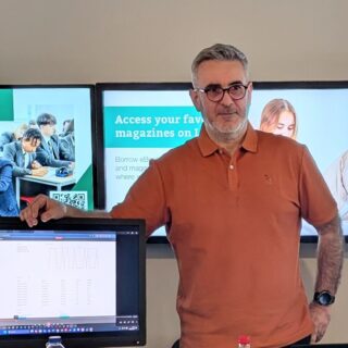 Cristian Iacob stood next to a computer screen at a showcase event.