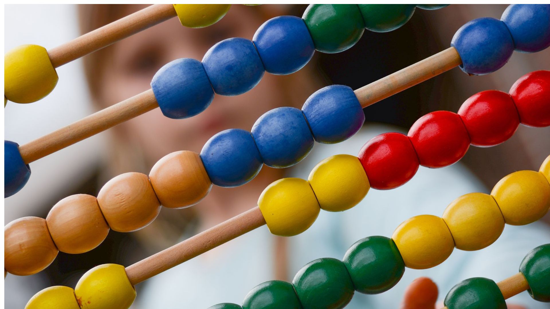 Close up of a child's multicoloured wooden abacus with beads