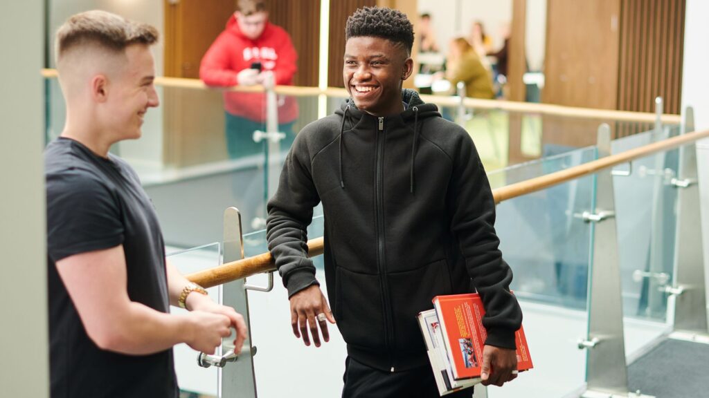 Two students talking in the Law and Psychology building