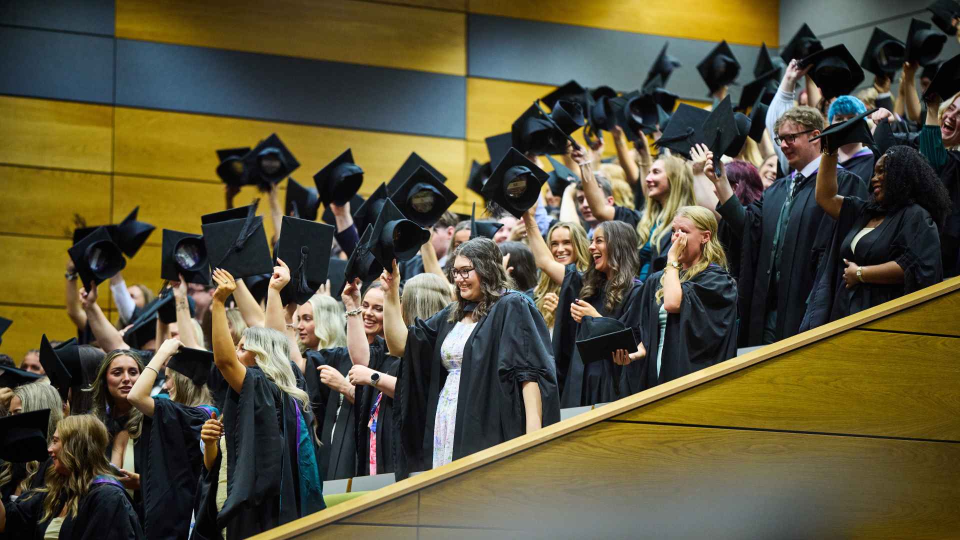 Graduate raising caps