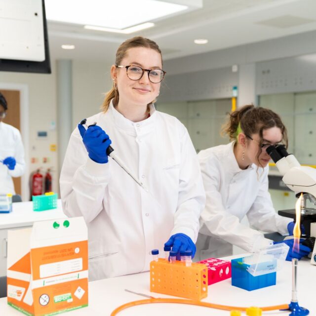 Alice Thomas stood in a lab