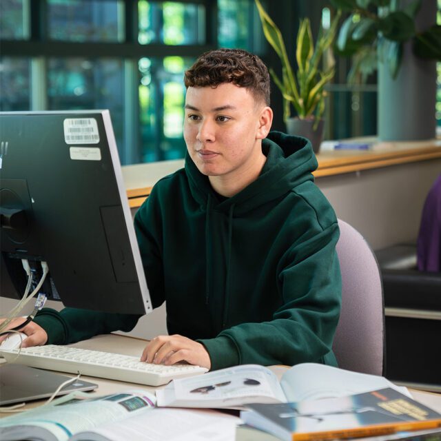Alex Sykes studying on the computer