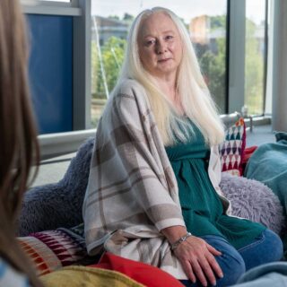 Fiona sat on a beanbag in a therapy setting