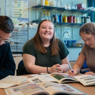 Amelia Burr sat at a table with books on