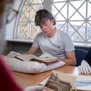 James Tidd reading a historic artifact