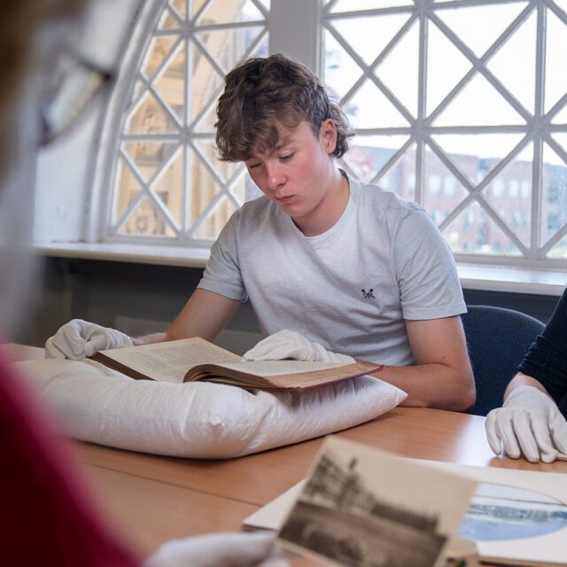 James Tidd reading a historic artifact