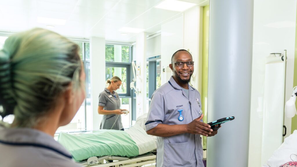 Four Midwifery students practicing on a birthing mannequin in the Clinical Skills and Simulation Centre ward