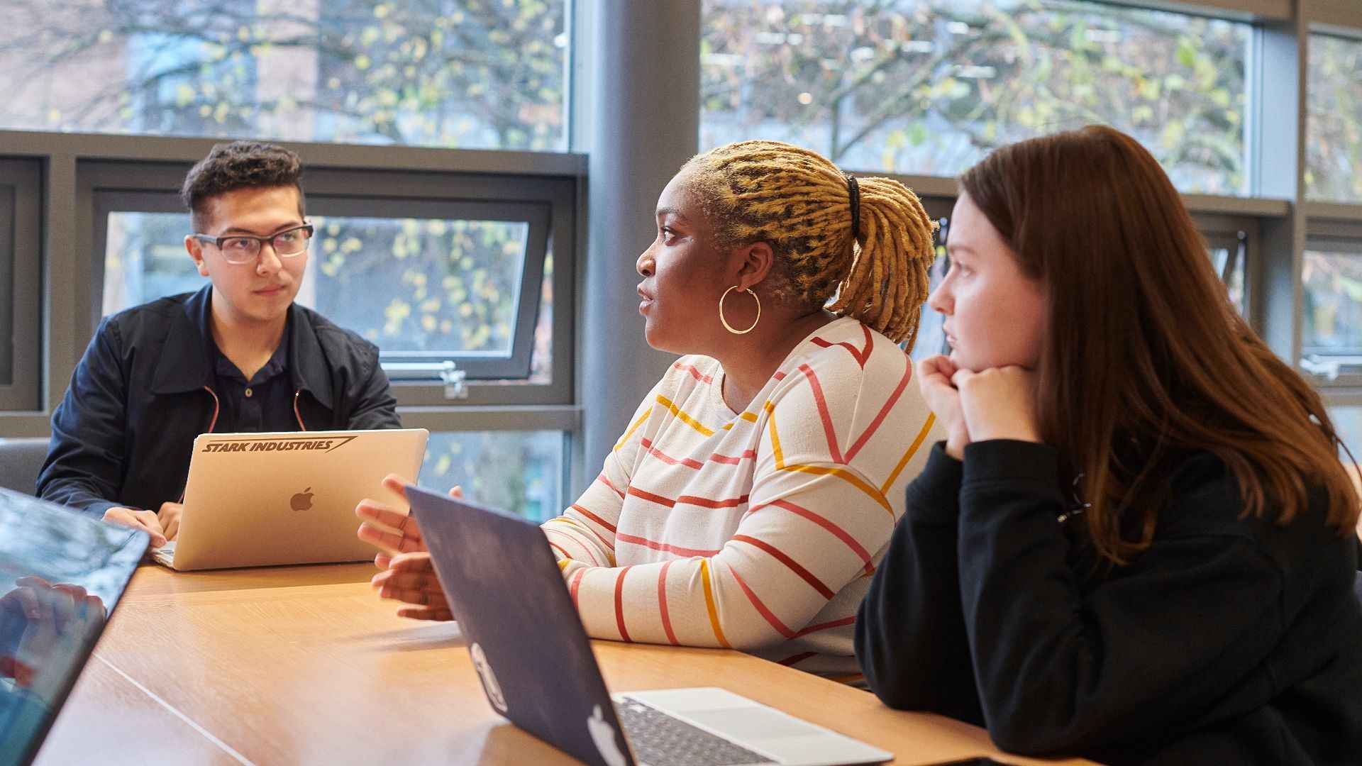 A group of students talking at a table.