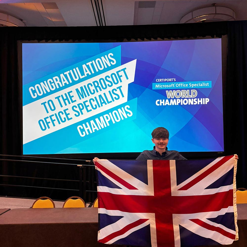 Thomas on stage holding UK flag - image provided by Thomas