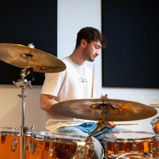 Gruff Rhys, music production student, playing drums.