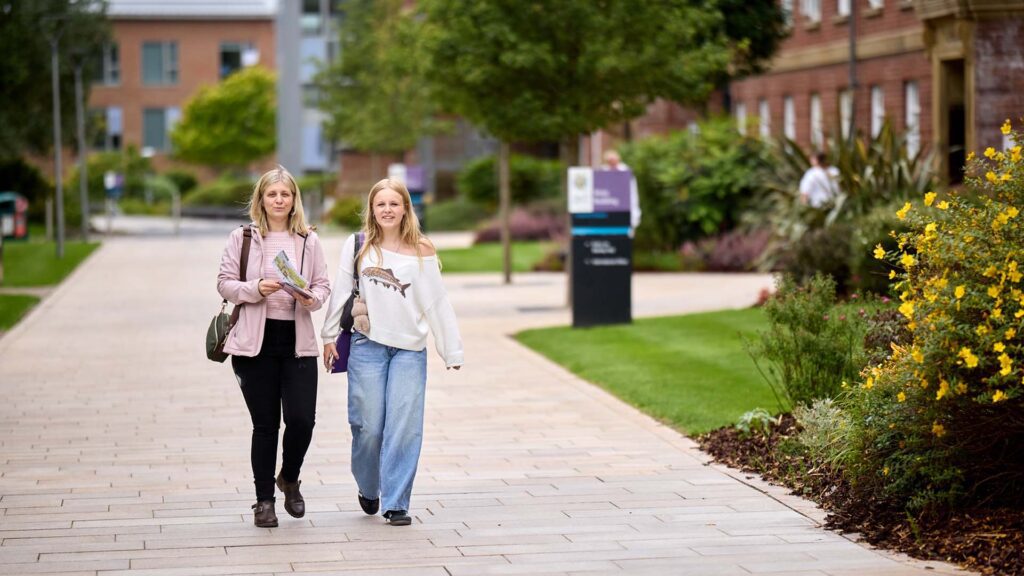 Image of visitor with parent/supporter outside of Main Building during an open day