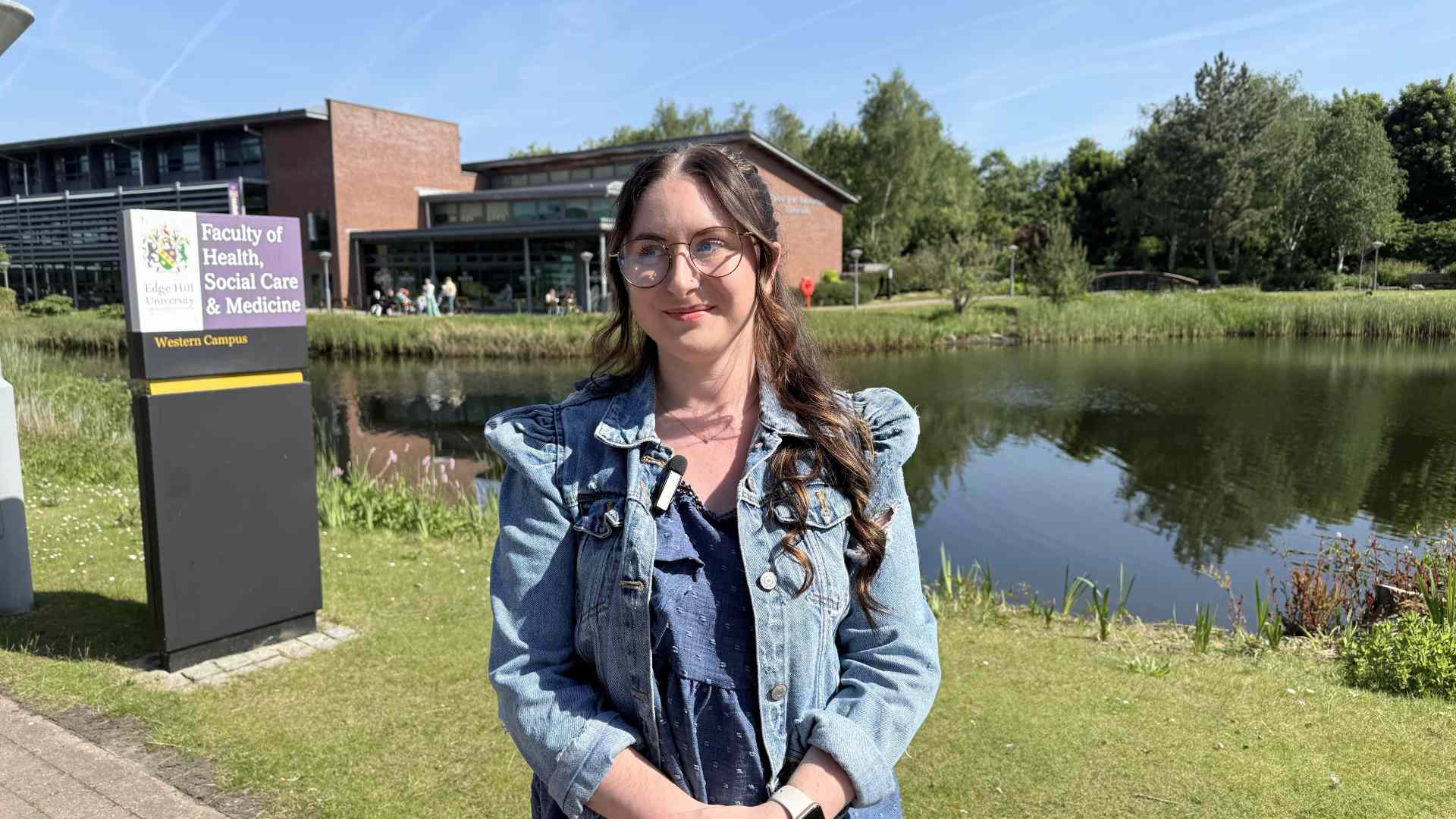 student, Abigaile standing outside health building at Edge Hill University.