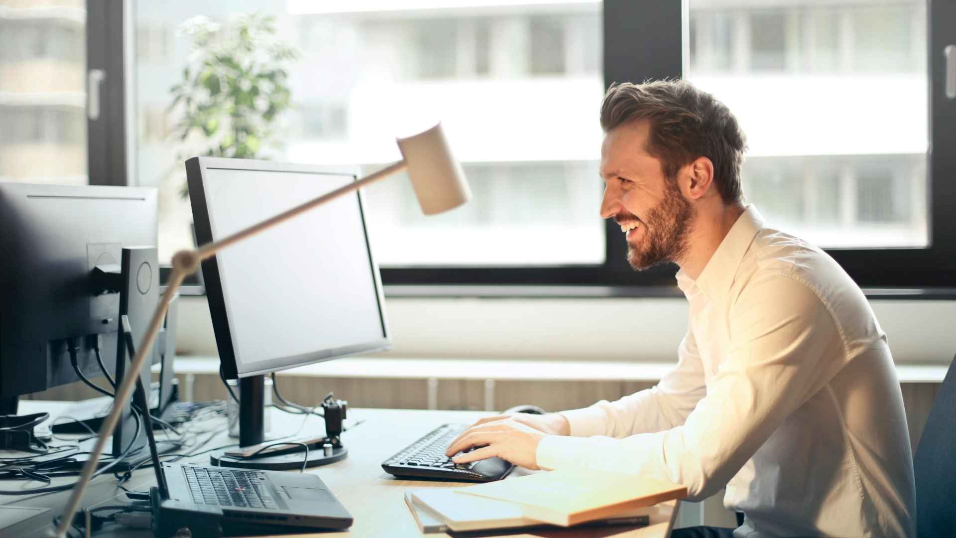 A man sat at a desk in an office.