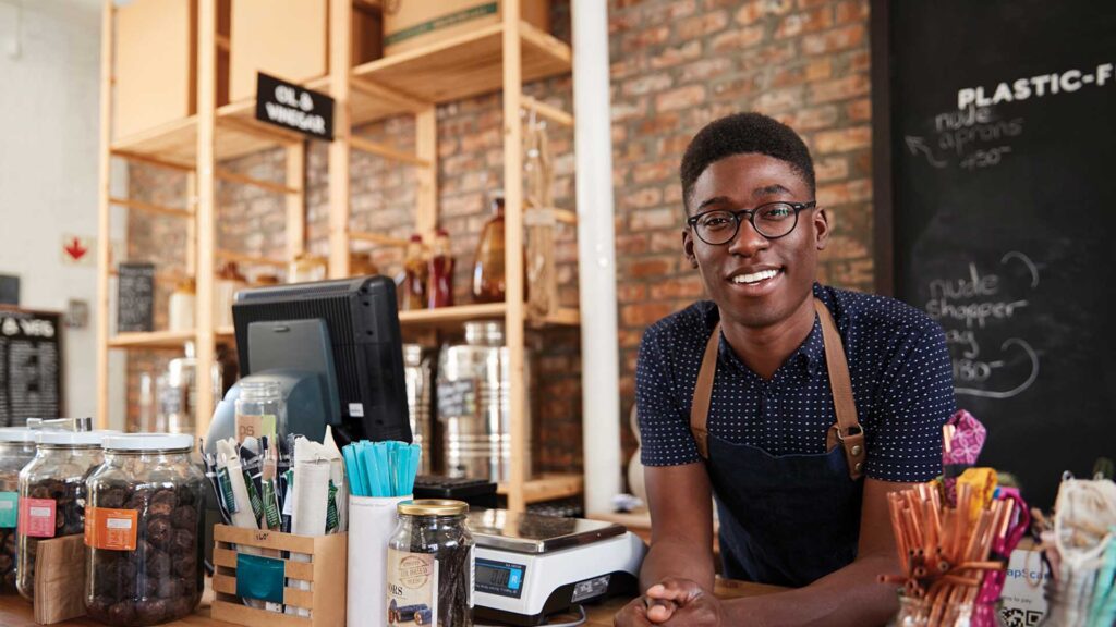 Student working behind the counter in a cafe.
